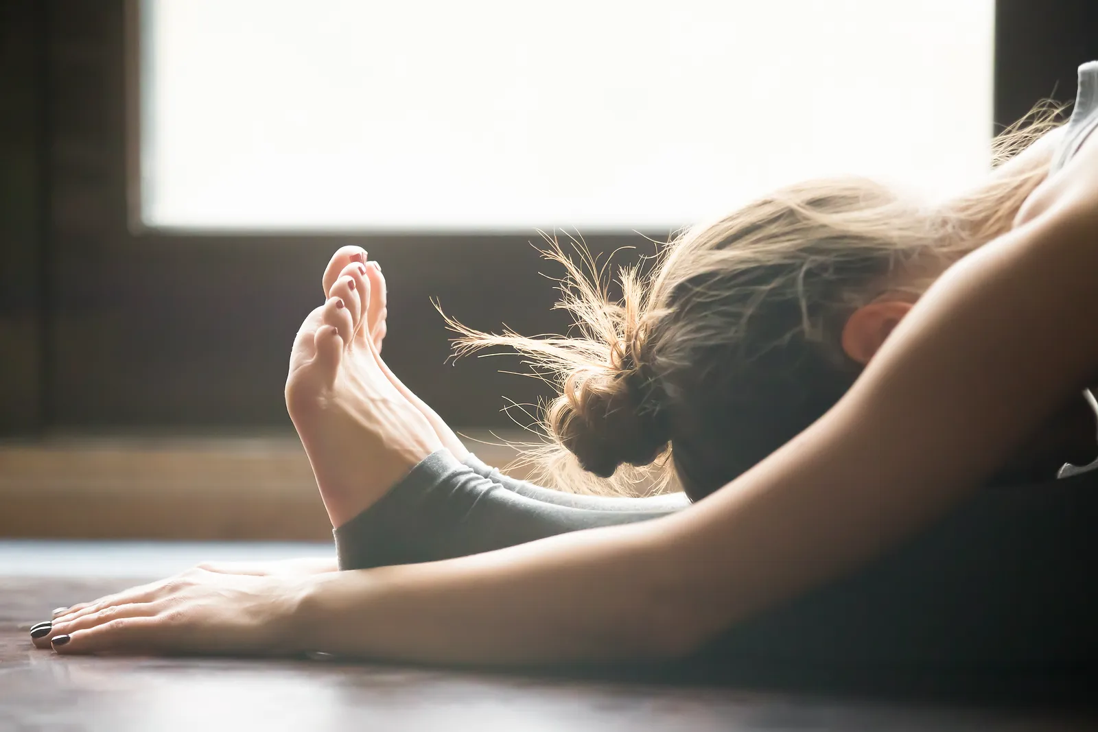 Young woman practicing yoga, sitting in